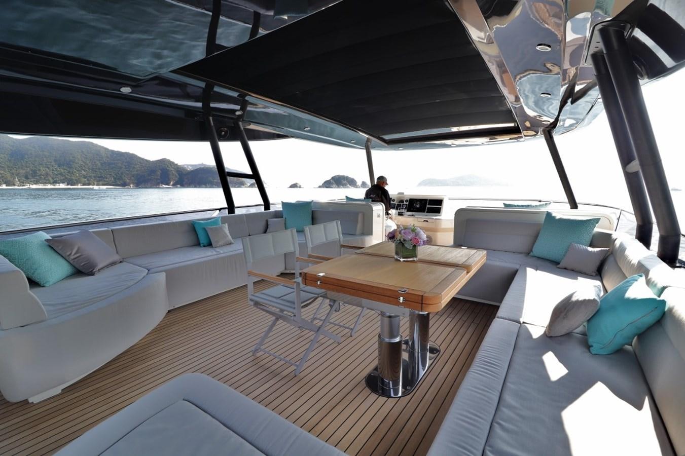 a boat with a table and chairs aboard MONTE CARLO YACHTS 86 Yacht for Sale