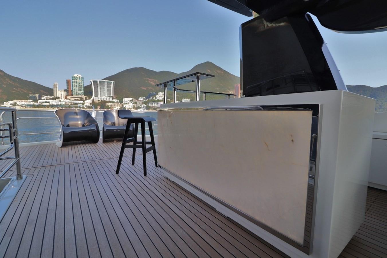 a deck with a large white screen and a city in the background aboard MONTE CARLO YACHTS 86 Yacht for Sale