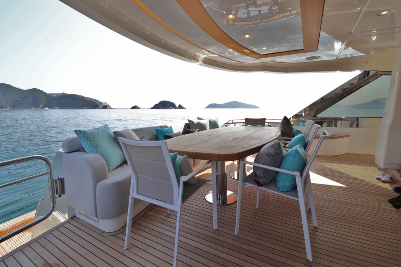 a person sitting on a boat aboard MONTE CARLO YACHTS 86 Yacht for Sale