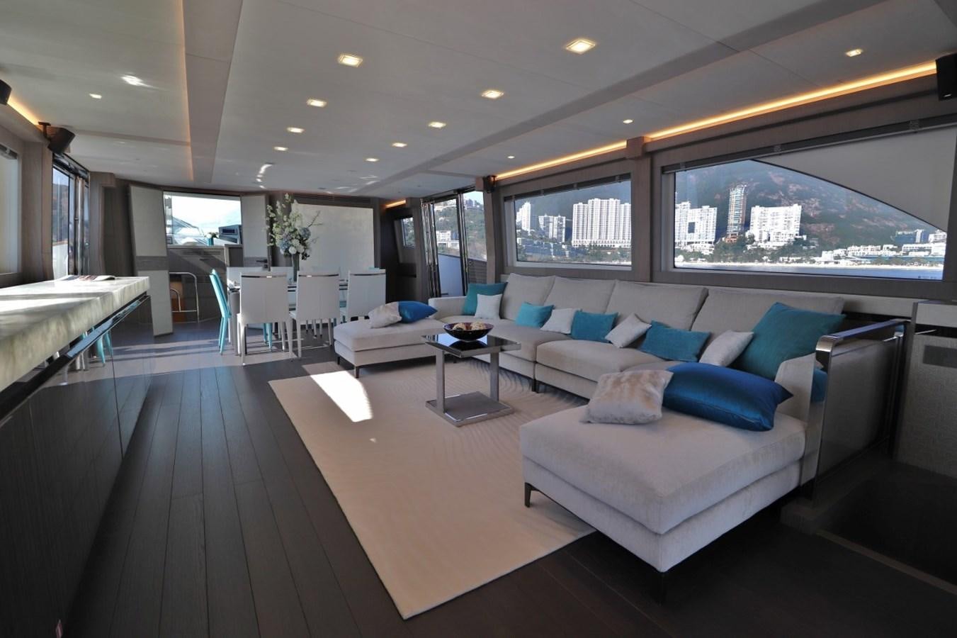 a living room with a large bed aboard MONTE CARLO YACHTS 86 Yacht for Sale