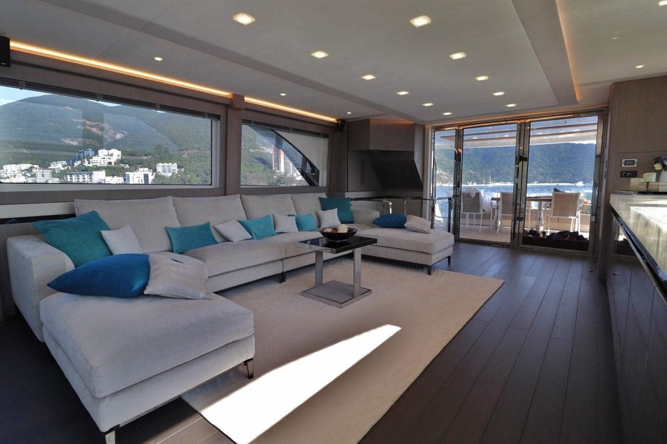 a room with a couch and a table aboard MONTE CARLO YACHTS 86 Yacht for Sale