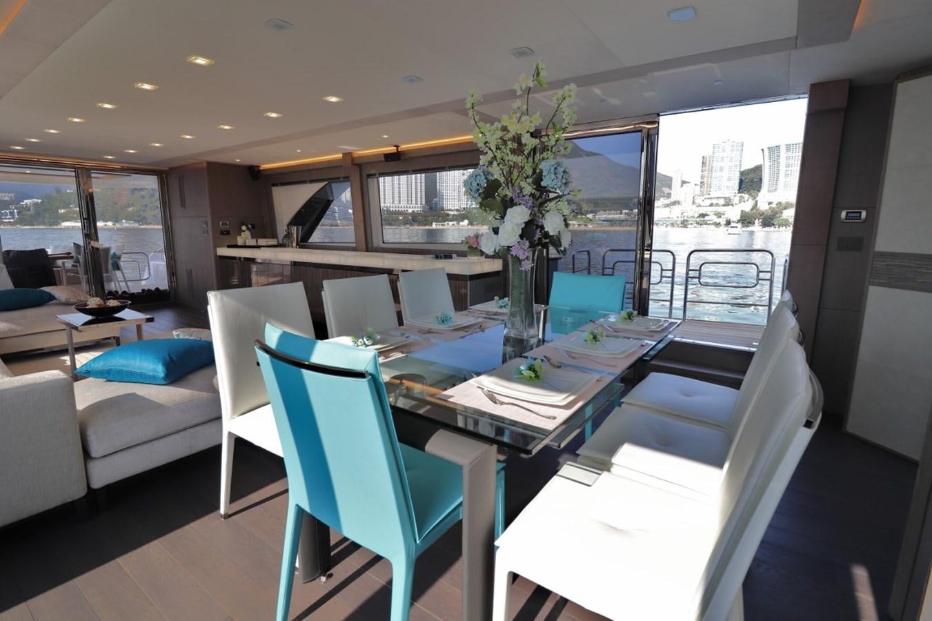 a dining room with a table and chairs aboard MONTE CARLO YACHTS 86 Yacht for Sale