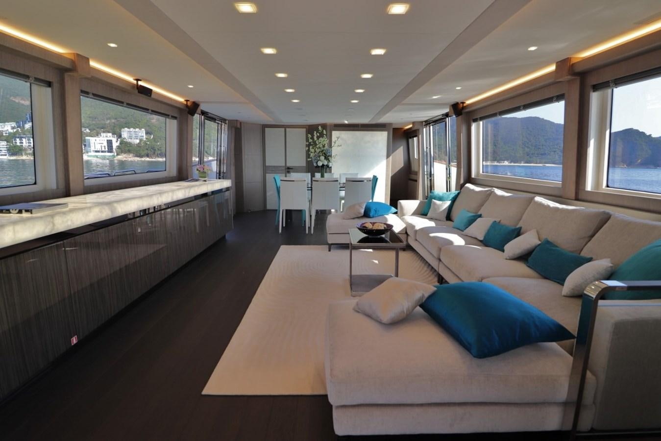 a large room with a couch and a television aboard MONTE CARLO YACHTS 86 Yacht for Sale