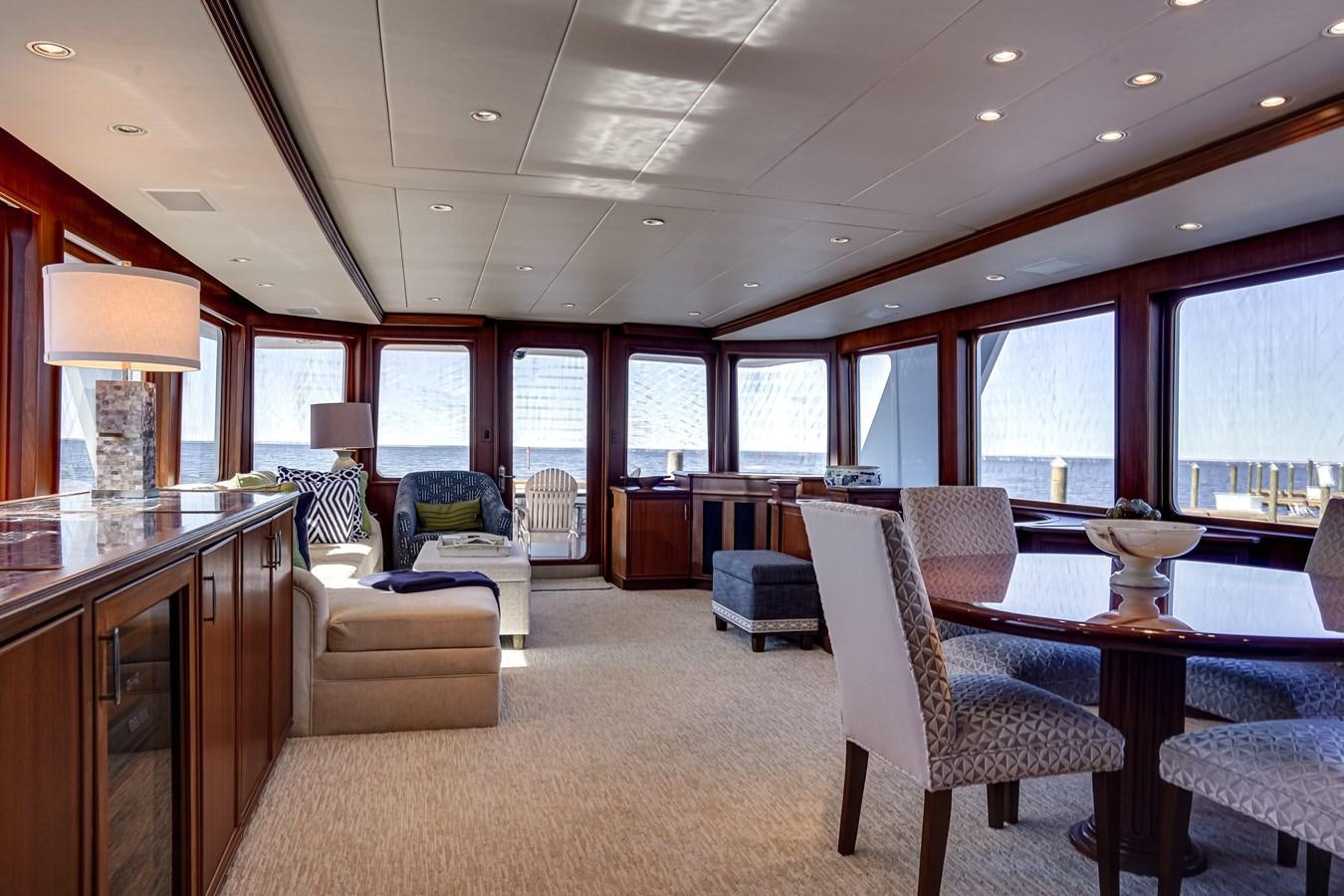 a large room with a table and chairs aboard CHECKERS Yacht for Sale