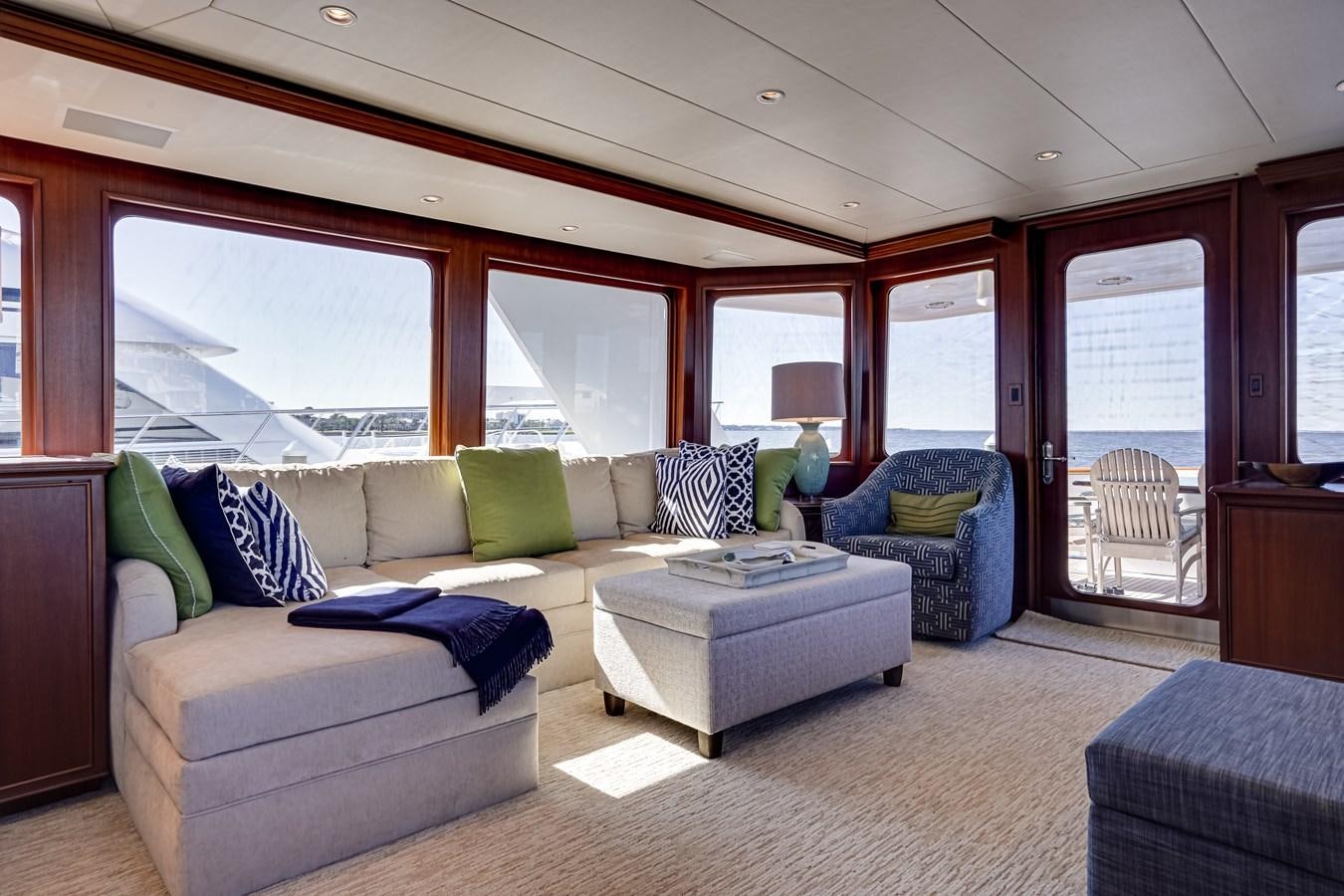 a living room with a blue couch aboard CHECKERS Yacht for Sale