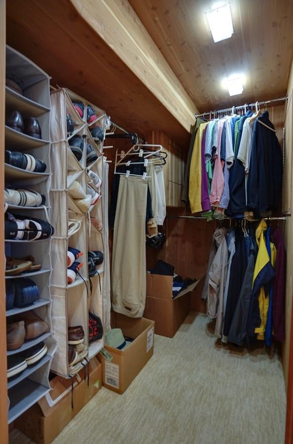 a room with shelves and clothes aboard CHECKERS Yacht for Sale