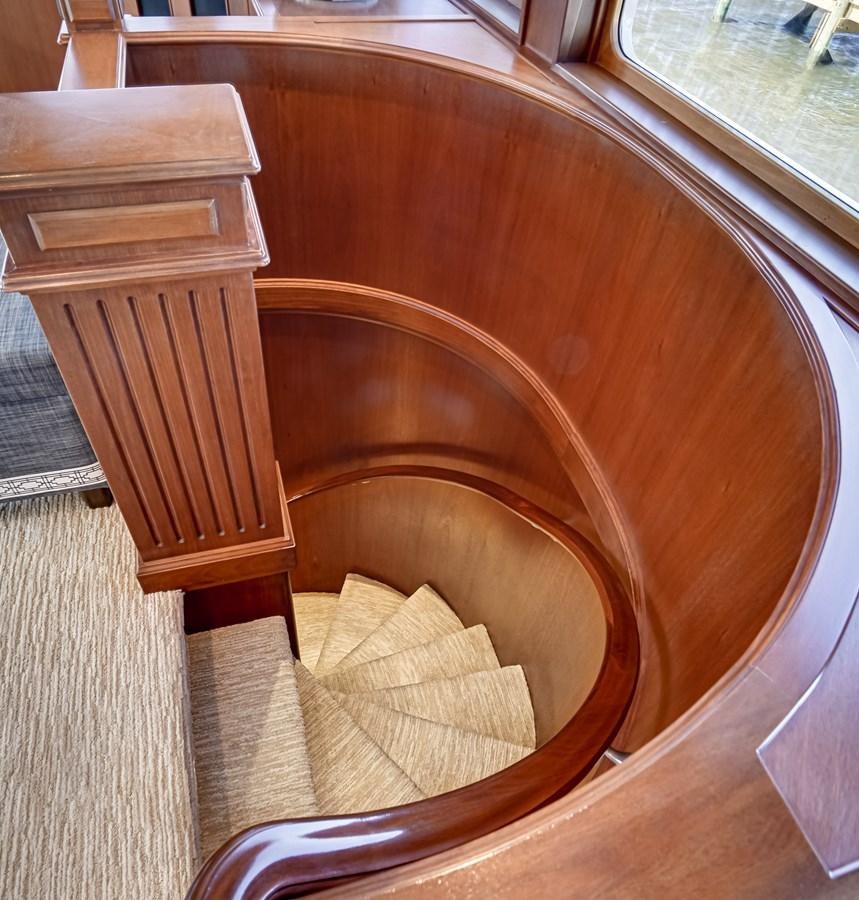 a wooden table with chairs aboard CHECKERS Yacht for Sale