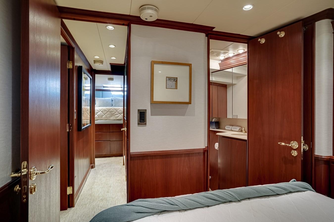a room with a bed and a mirror aboard CHECKERS Yacht for Sale