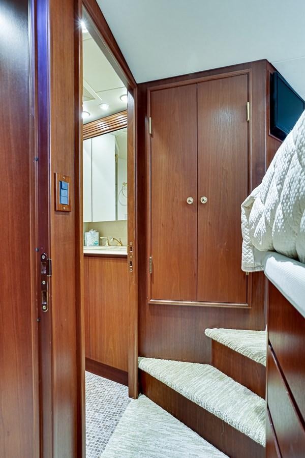 a room with a bed and a mirror aboard CHECKERS Yacht for Sale