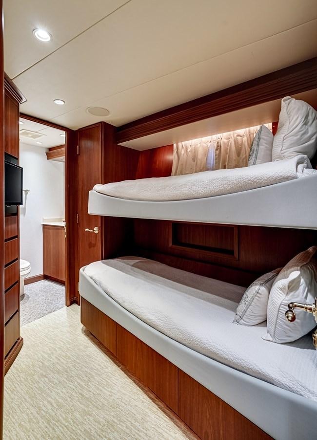 a bed with white sheets aboard CHECKERS Yacht for Sale