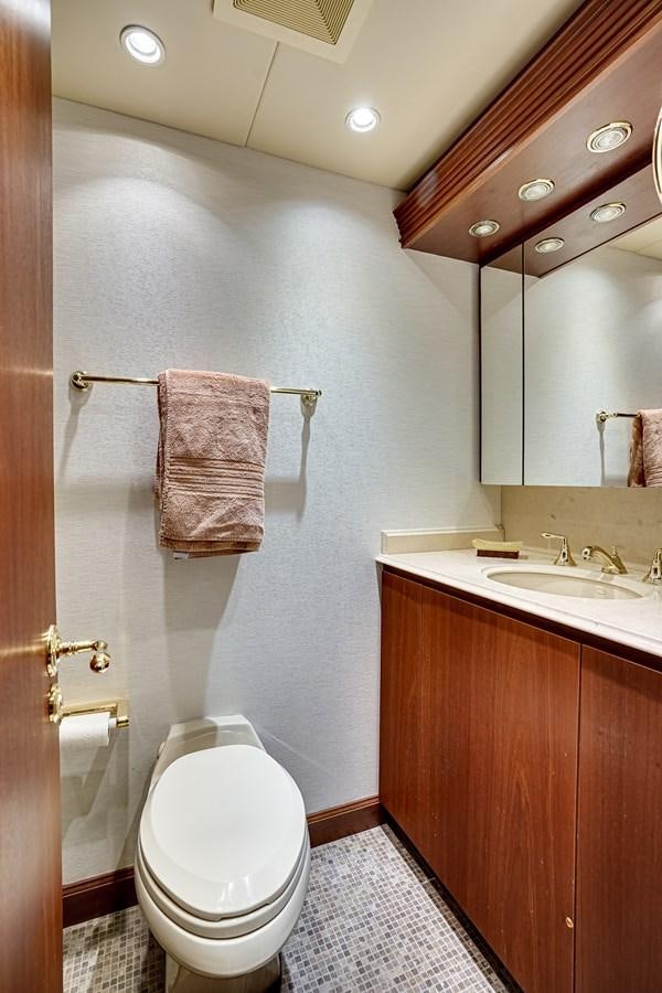 a bathroom with a toilet and sink aboard CHECKERS Yacht for Sale