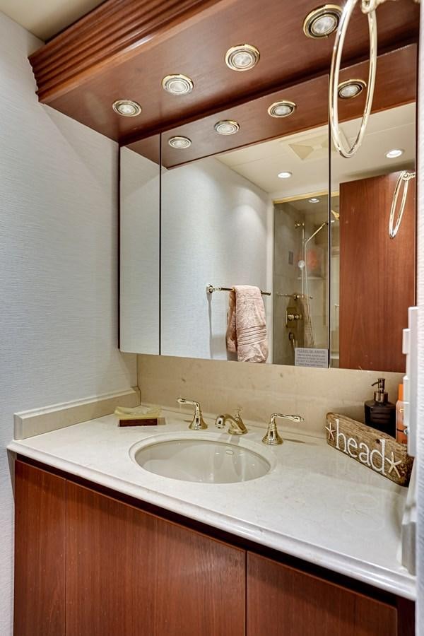 a bathroom with a sink and a mirror aboard CHECKERS Yacht for Sale