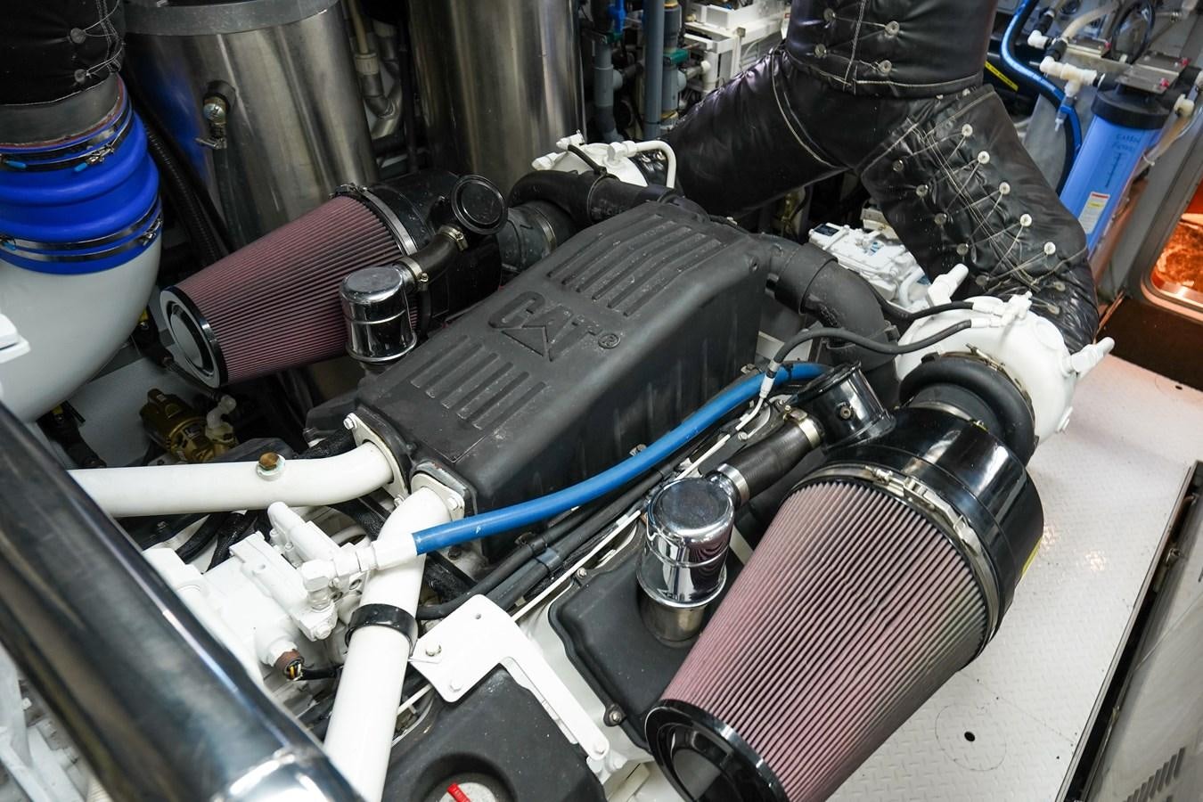 a person working on a car engine aboard CHECKERS Yacht for Sale