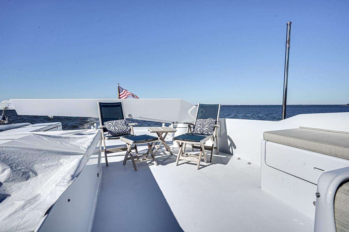 a deck with chairs and tables on it aboard CHECKERS Yacht for Sale