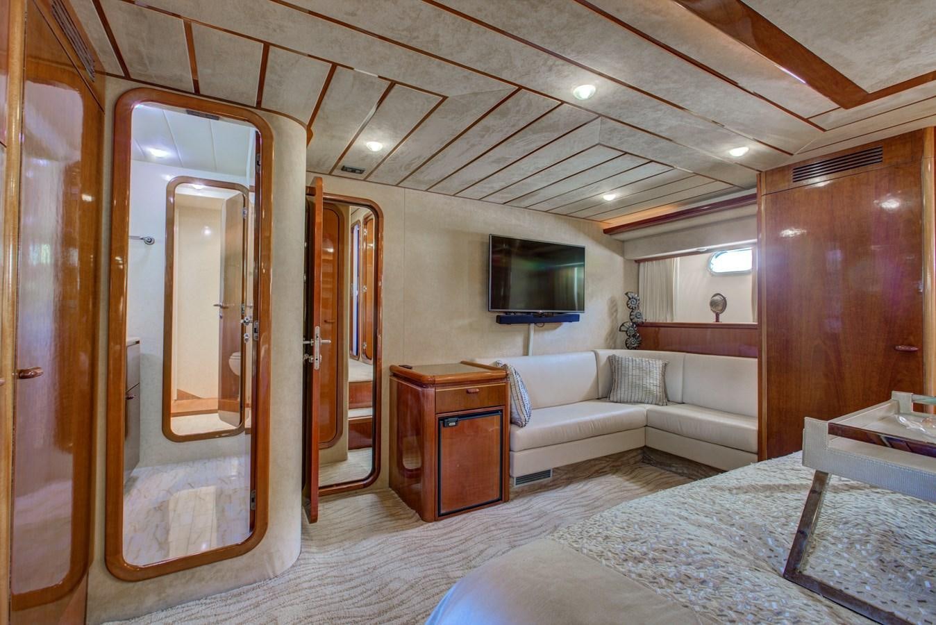 a large bedroom with a bed and a tv aboard FERRETTI Yacht for Sale