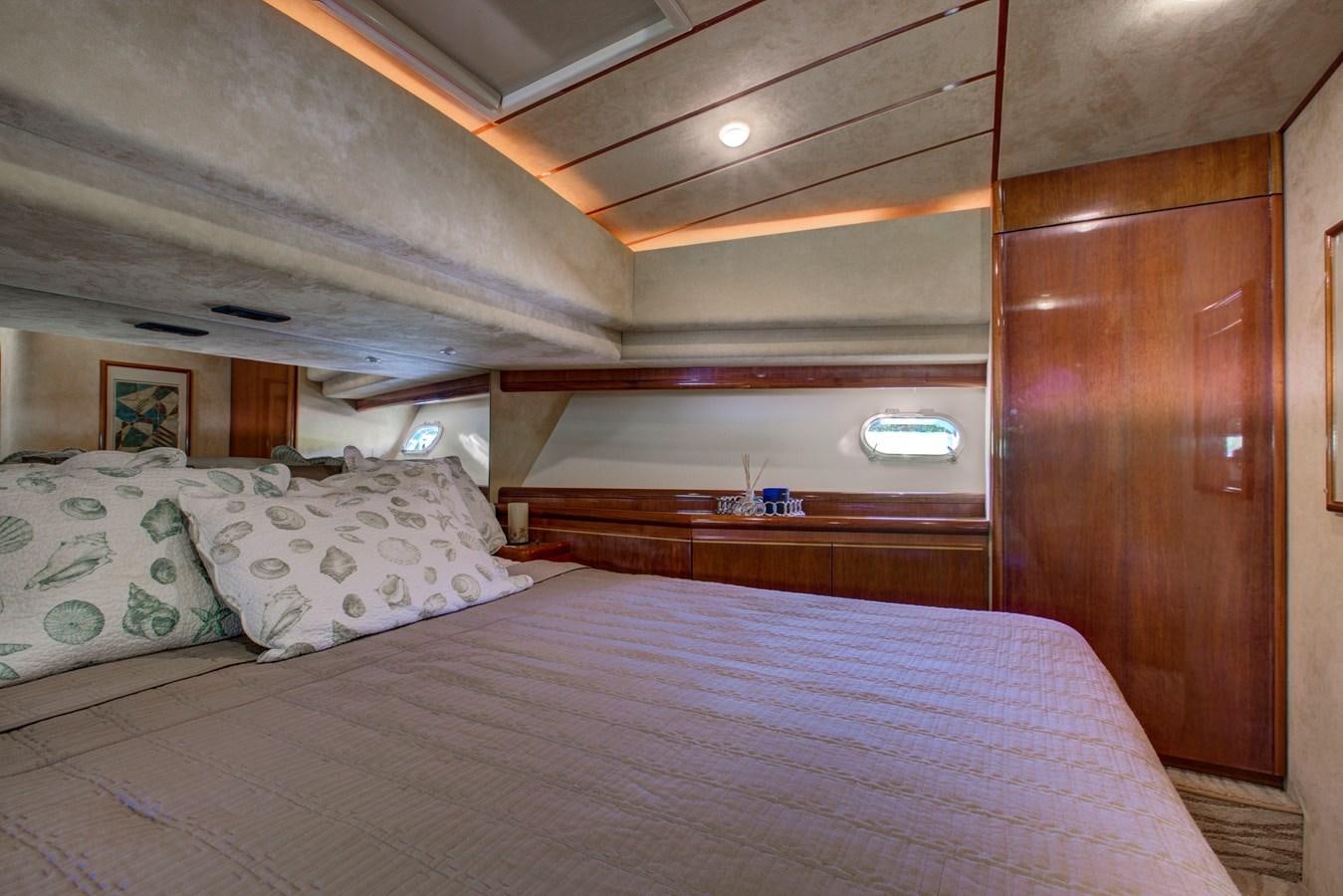 a bed with pillows aboard FERRETTI Yacht for Sale
