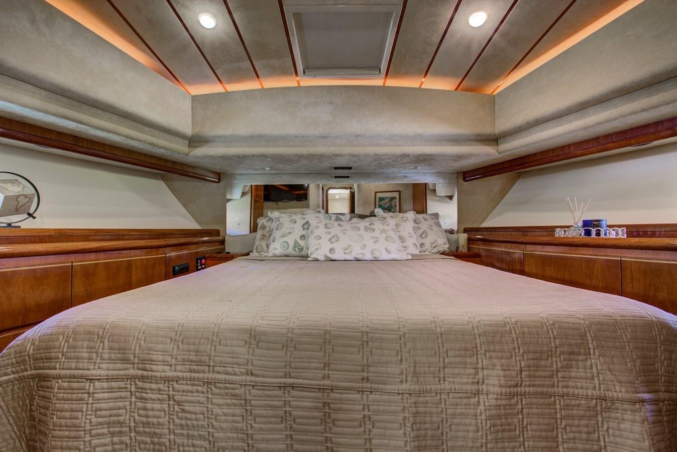 a bed with white sheets aboard FERRETTI Yacht for Sale