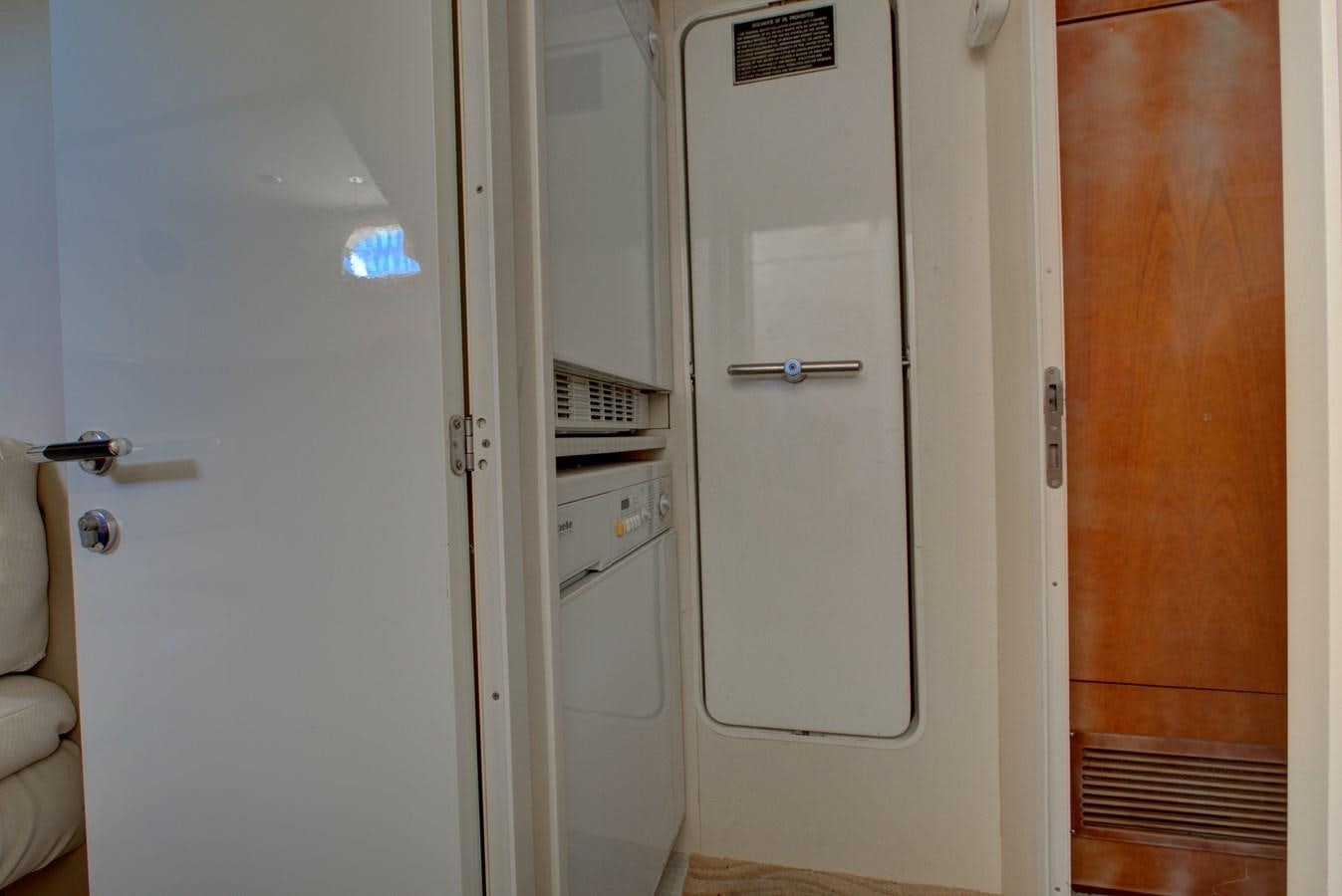 a closet with white doors aboard FERRETTI Yacht for Sale