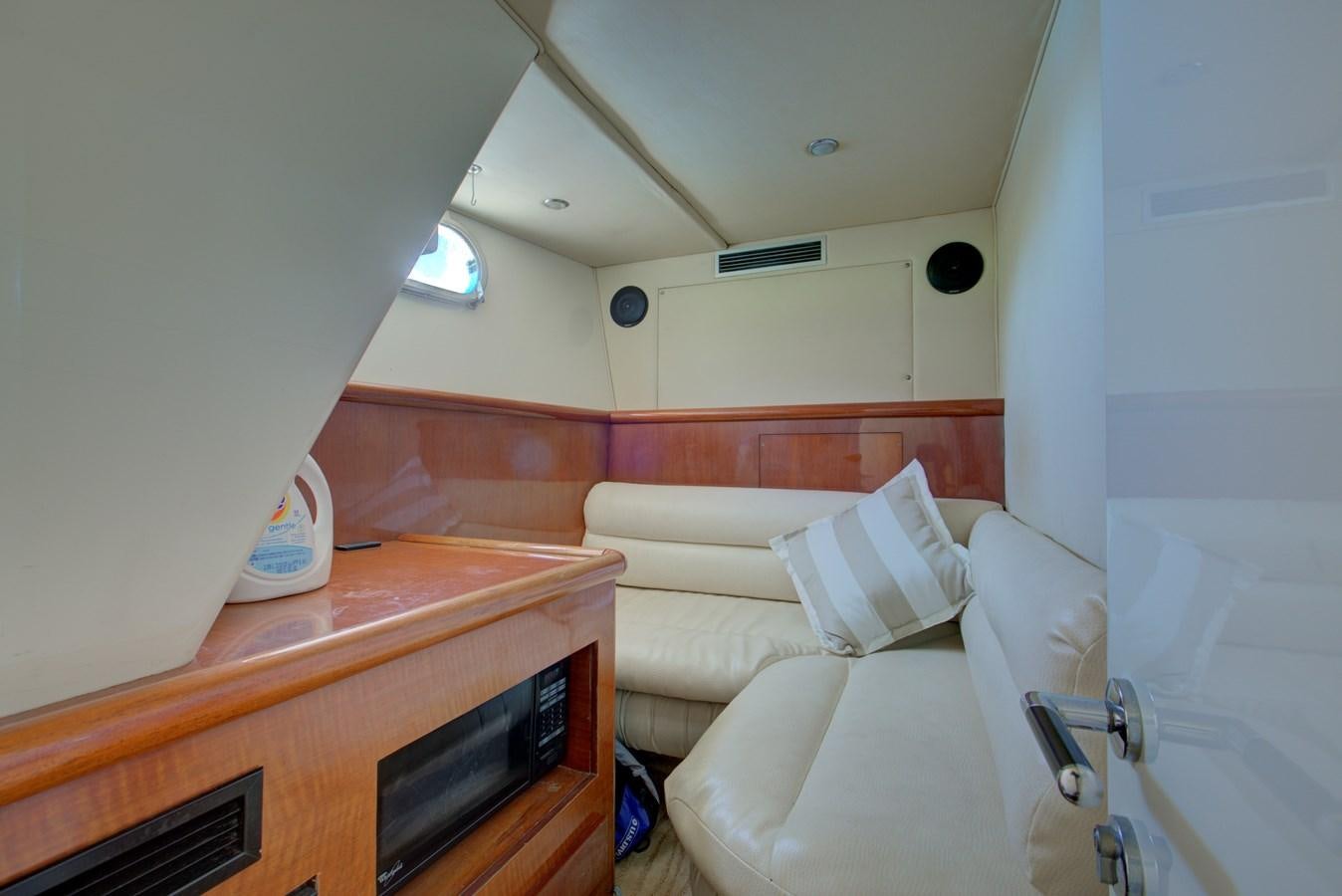 a small room with a bed and a desk aboard FERRETTI Yacht for Sale