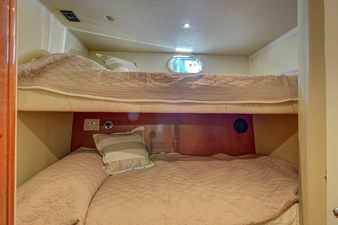 a bed with a bed and a round mirror aboard FERRETTI Yacht for Sale