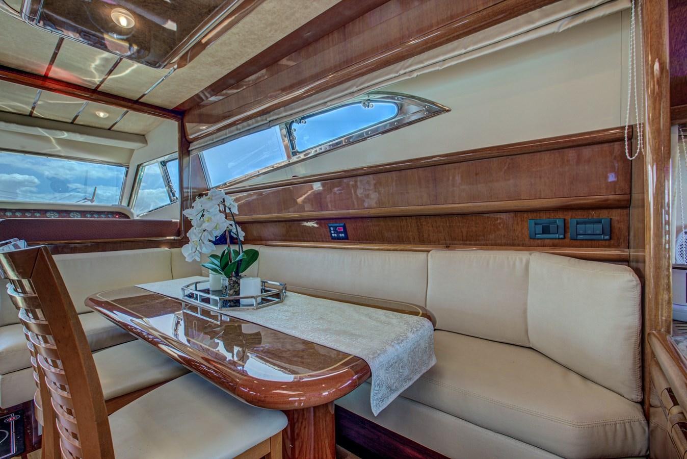 a room with a table and chairs aboard FERRETTI Yacht for Sale