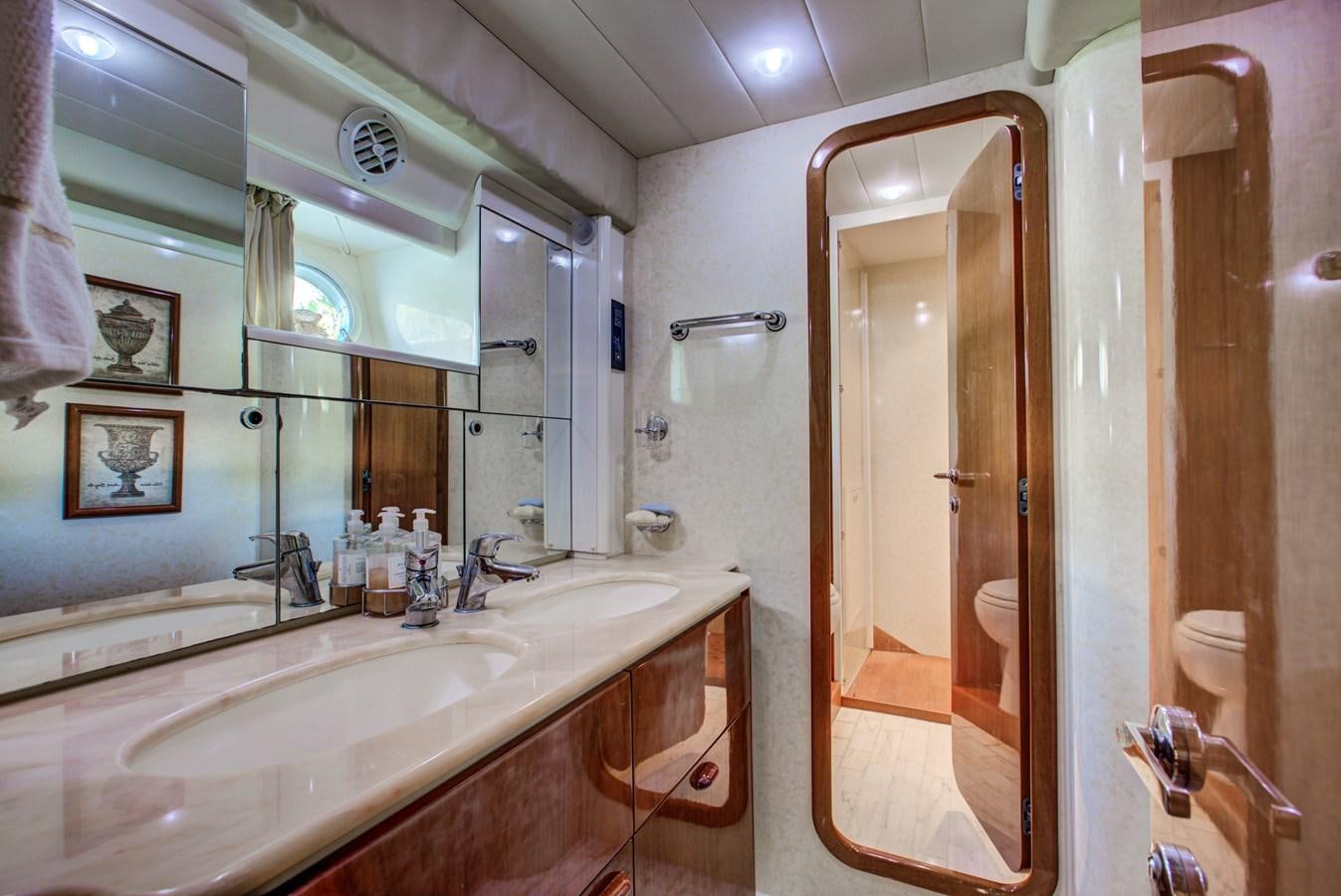 a bathroom with a large mirror aboard FERRETTI Yacht for Sale