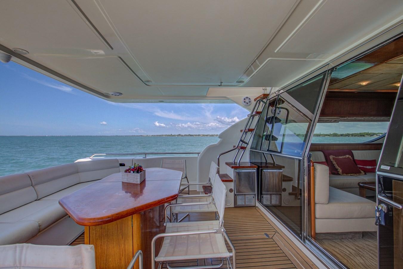 a boat with a table and chairs aboard FERRETTI Yacht for Sale