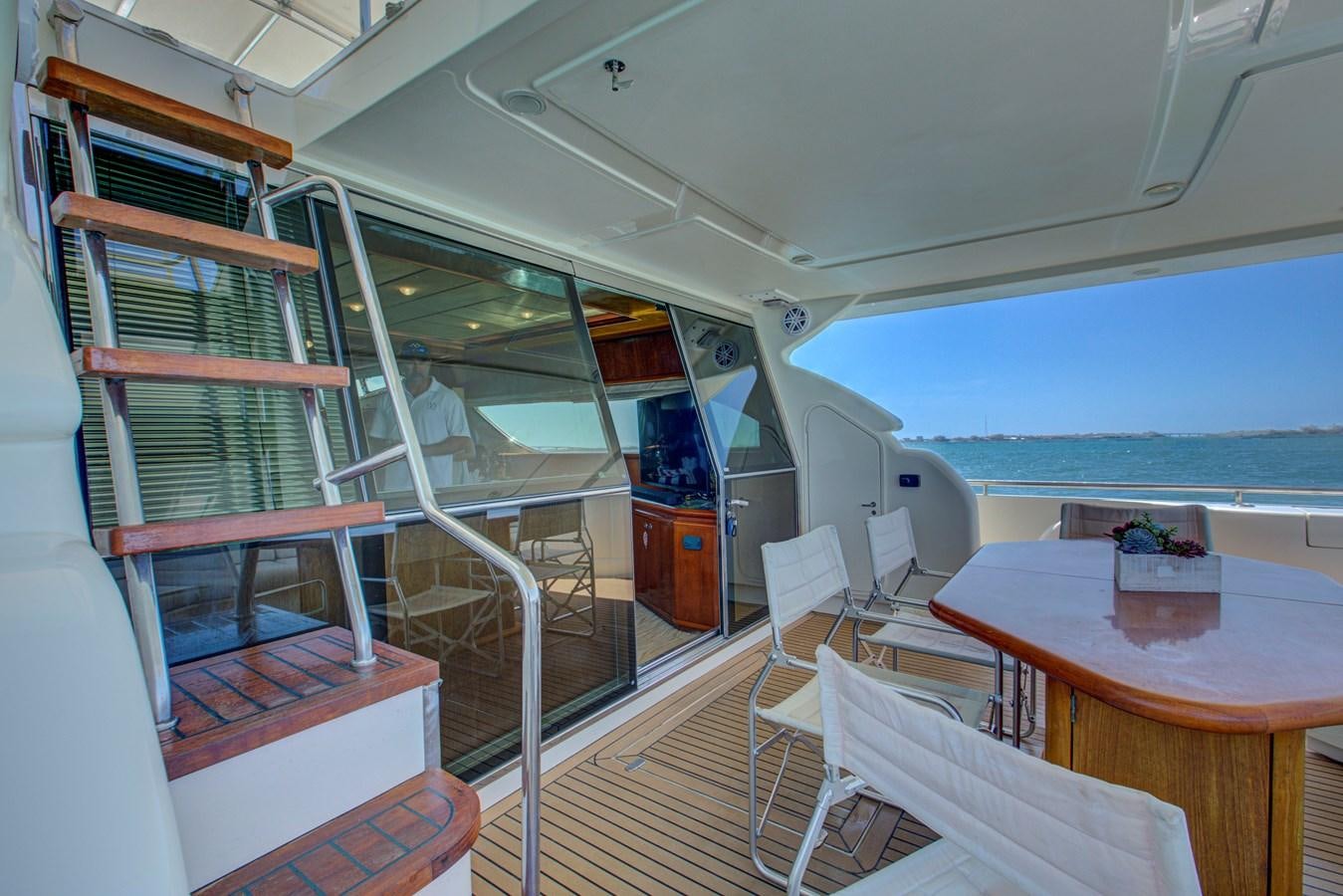 a room with a table and chairs aboard FERRETTI Yacht for Sale