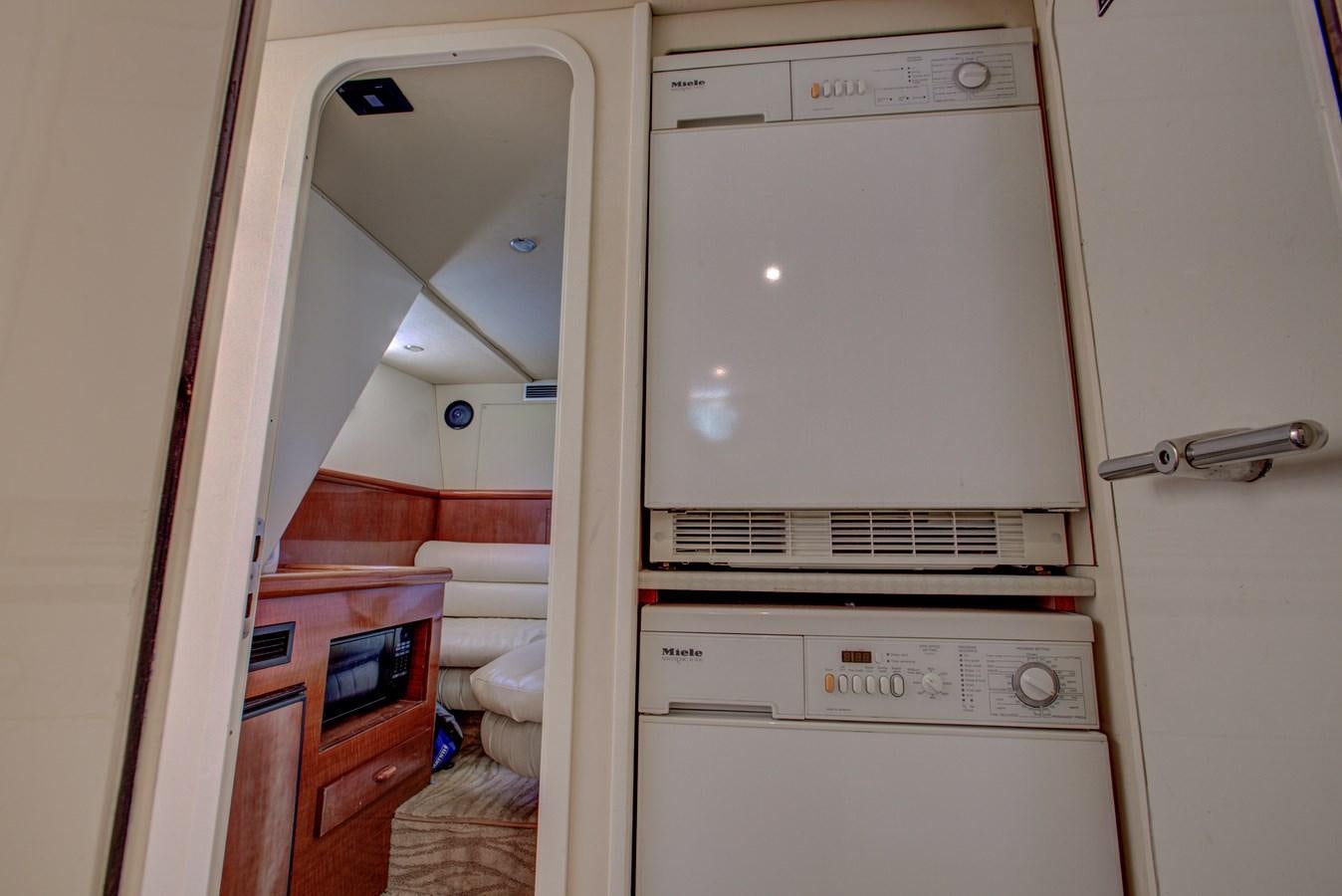 a laundry room with a washer and dryer aboard FERRETTI Yacht for Sale