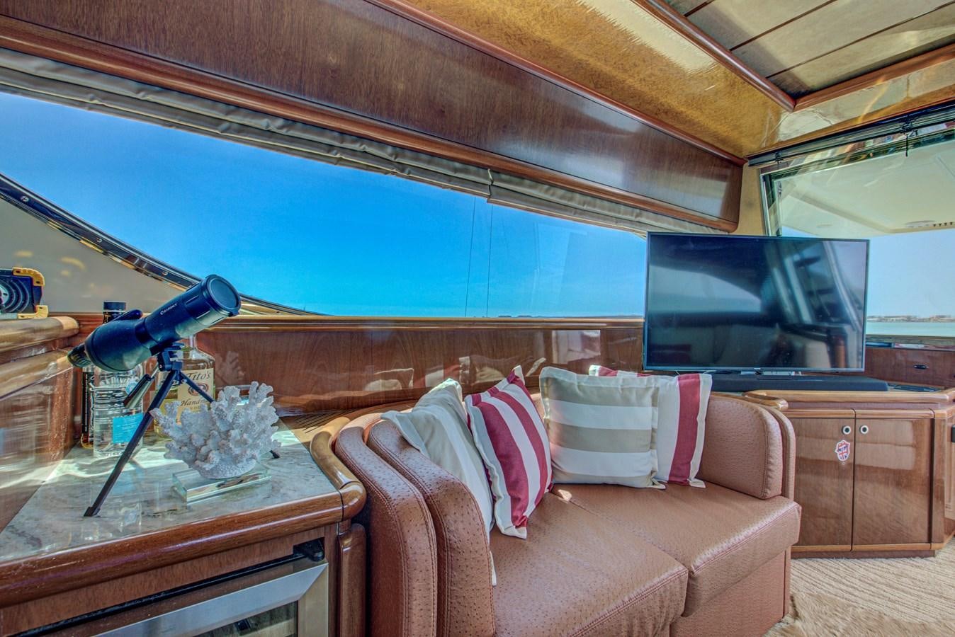 a room with a couch and a television aboard FERRETTI Yacht for Sale