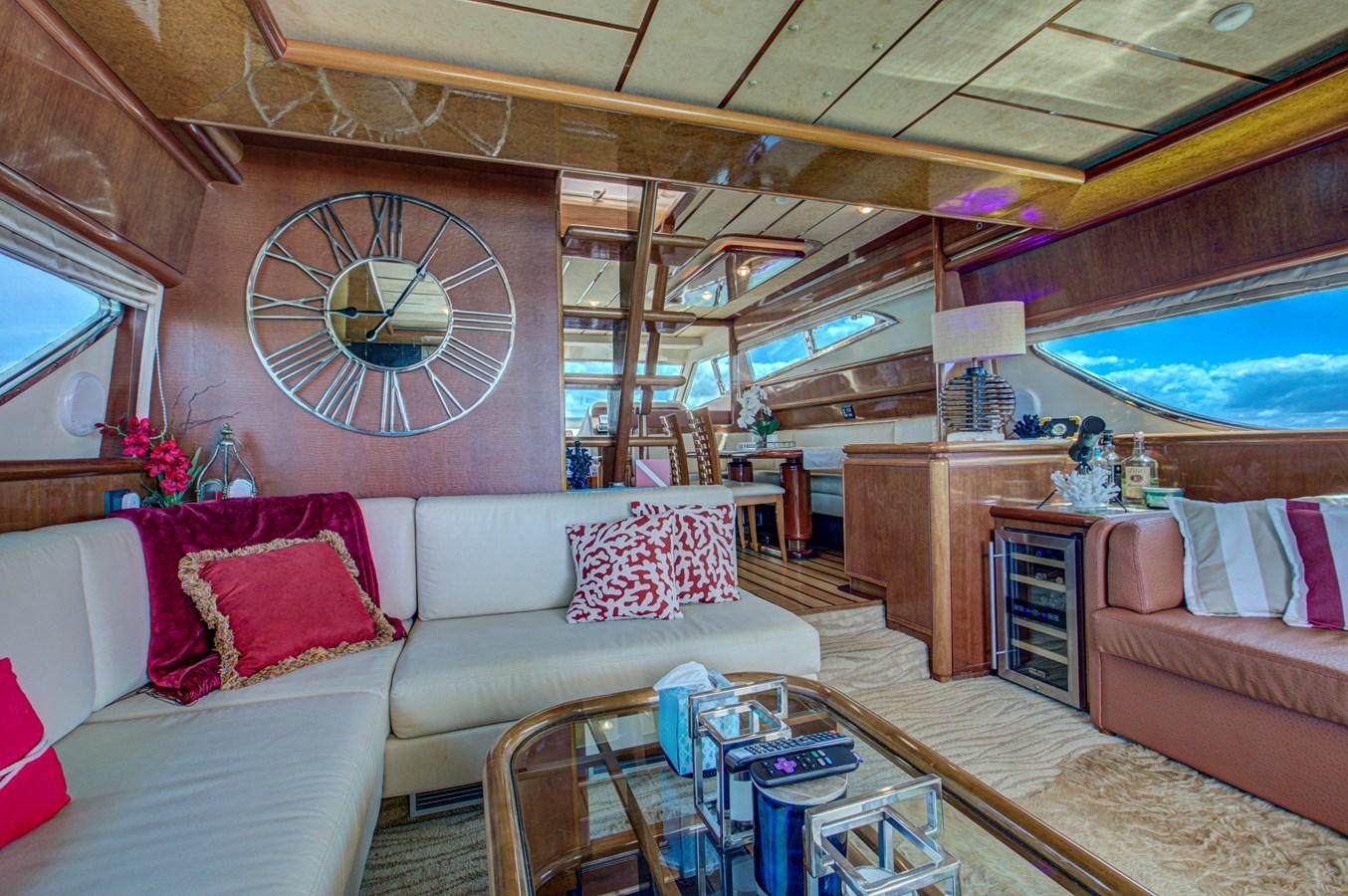 a living room with a clock aboard FERRETTI Yacht for Sale