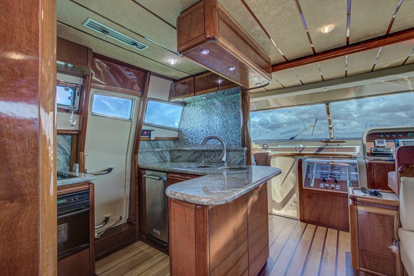 a kitchen with a sink and cabinets aboard FERRETTI Yacht for Sale