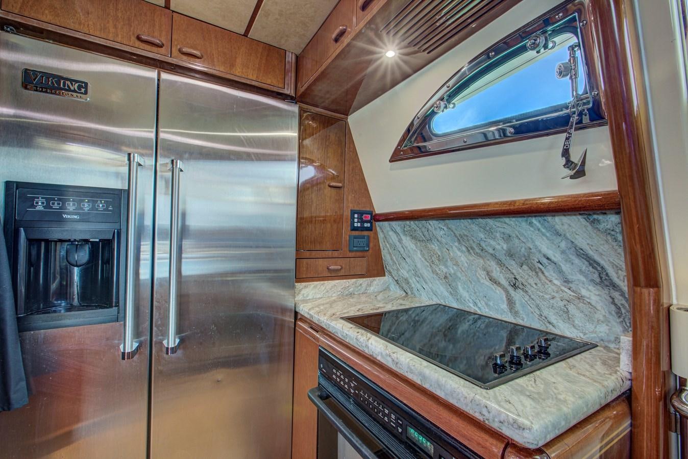 a kitchen with a large stainless steel refrigerator aboard FERRETTI Yacht for Sale