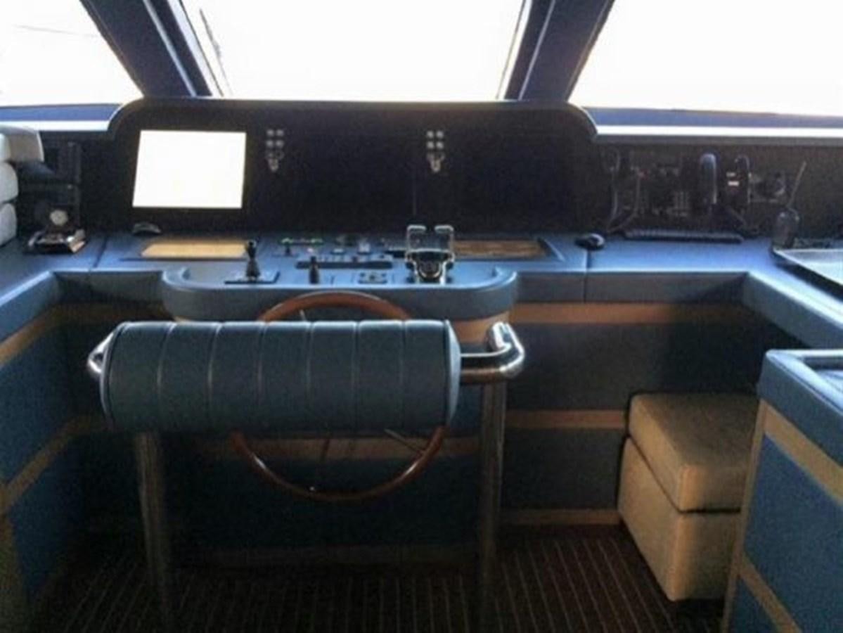 a large black piano with a wooden seat and a wooden chair in front of it aboard BENNETTI 105 Yacht for Sale