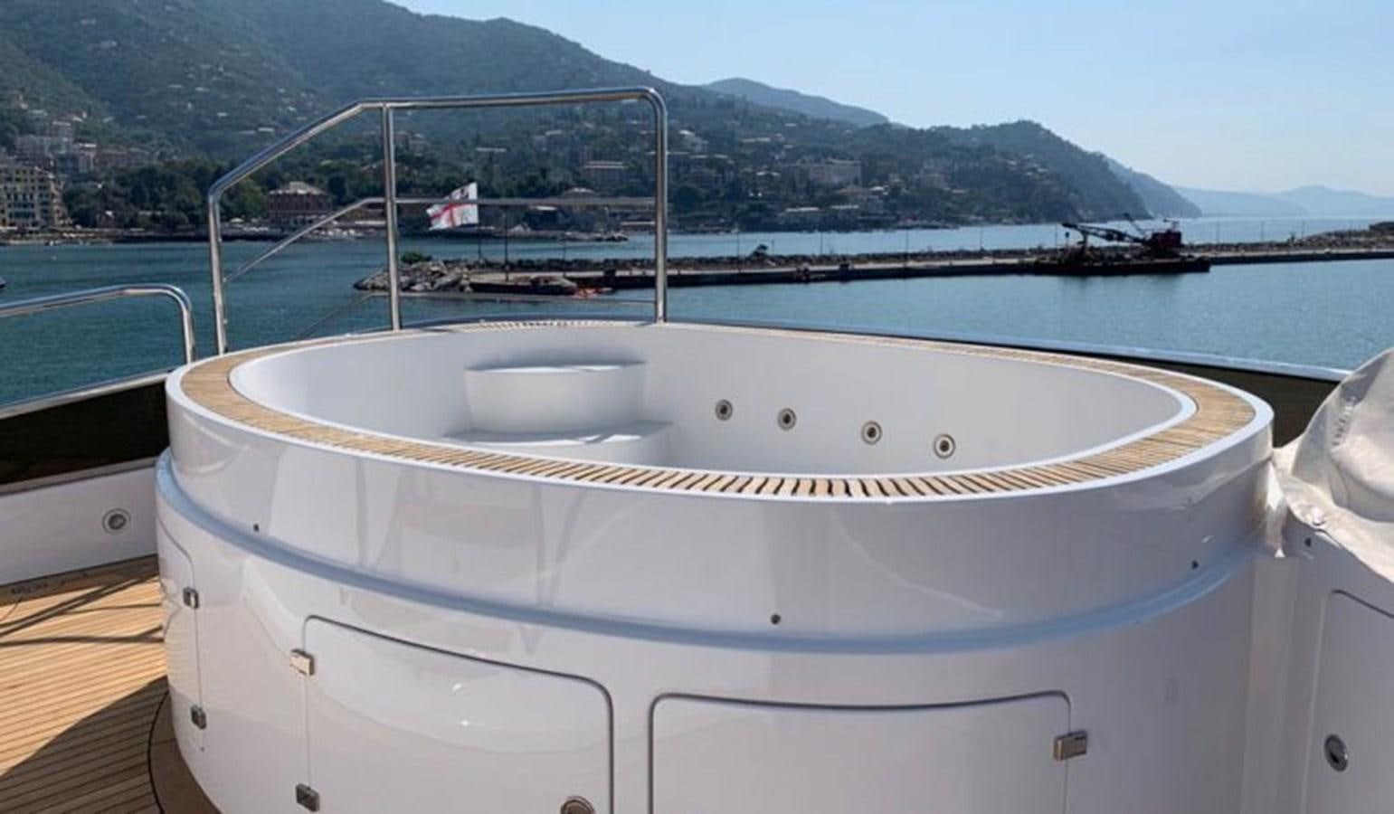 a white boat on a dock aboard BENNETTI 105 Yacht for Sale