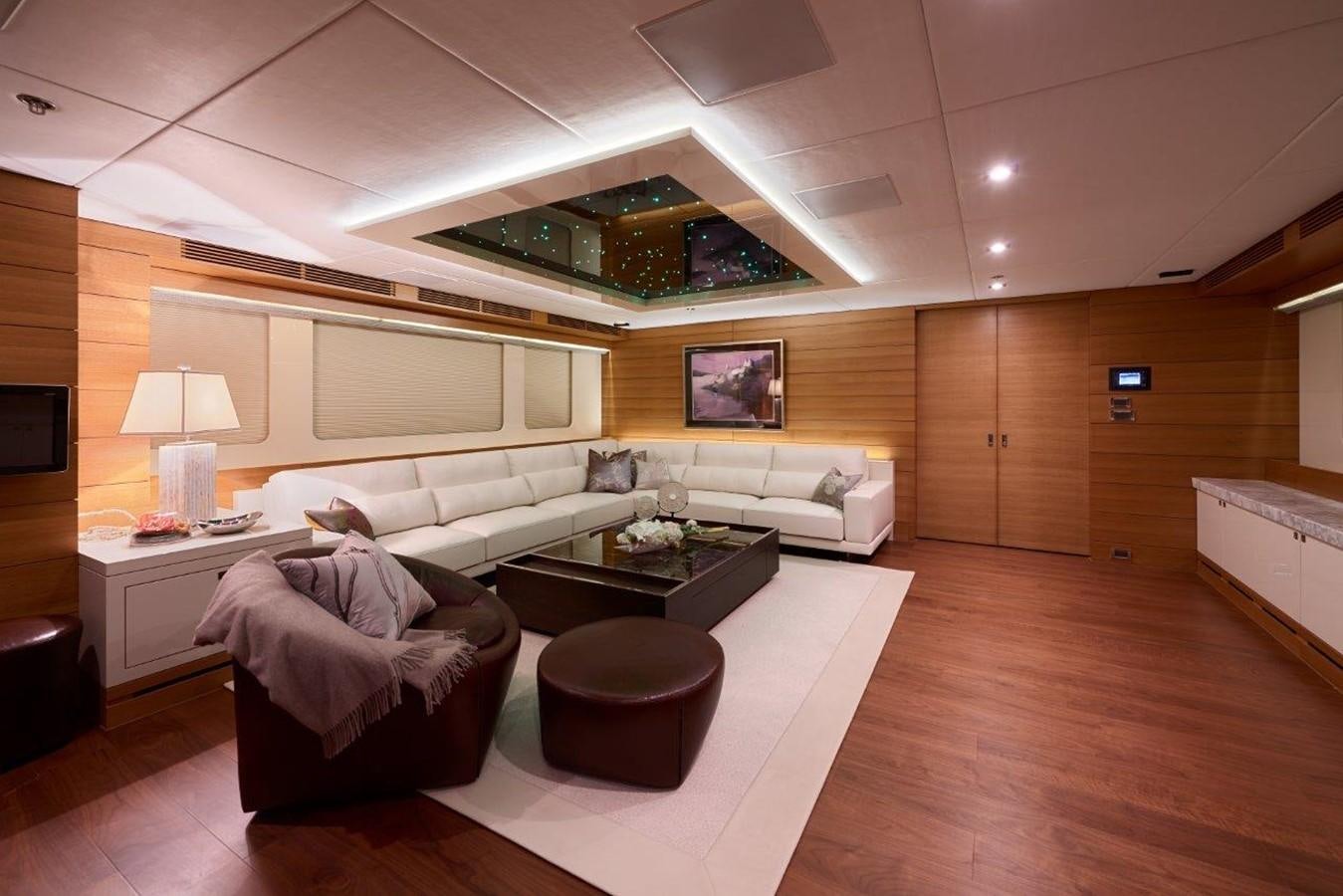a living room with a large couch aboard EP150 Yacht for Sale