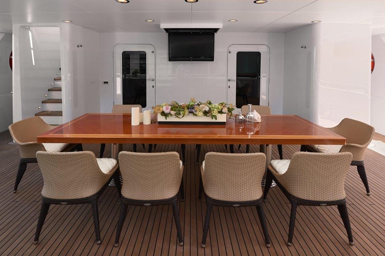 a table with chairs around it aboard EP150 Yacht for Sale