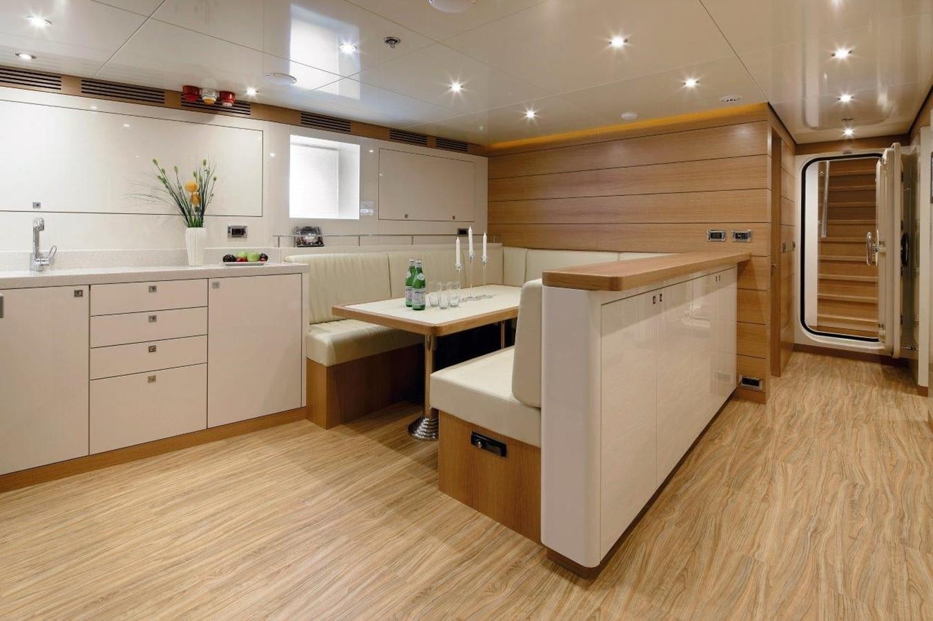 a kitchen with a table and cabinets aboard EP150 Yacht for Sale