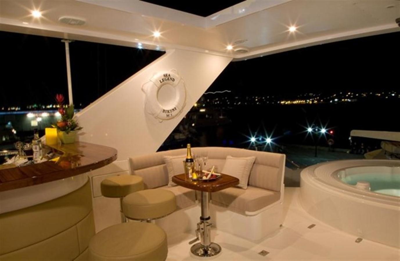 a room with a table and chairs aboard SEA LEGEND Yacht for Sale
