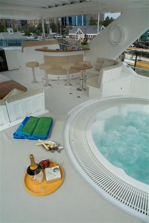 a room with a pool and a table and chairs aboard SEA LEGEND Yacht for Sale