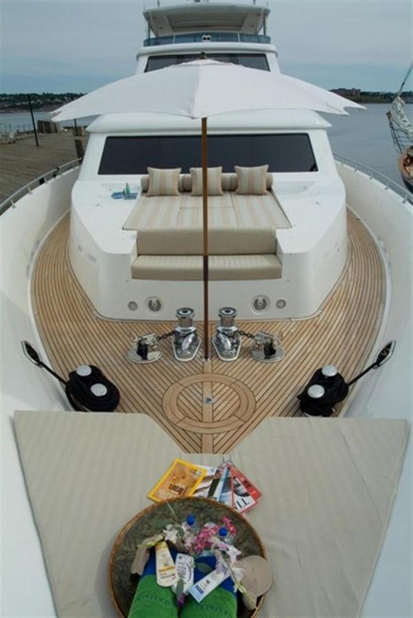 a white umbrella with a table and chairs on a deck aboard SEA LEGEND Yacht for Sale