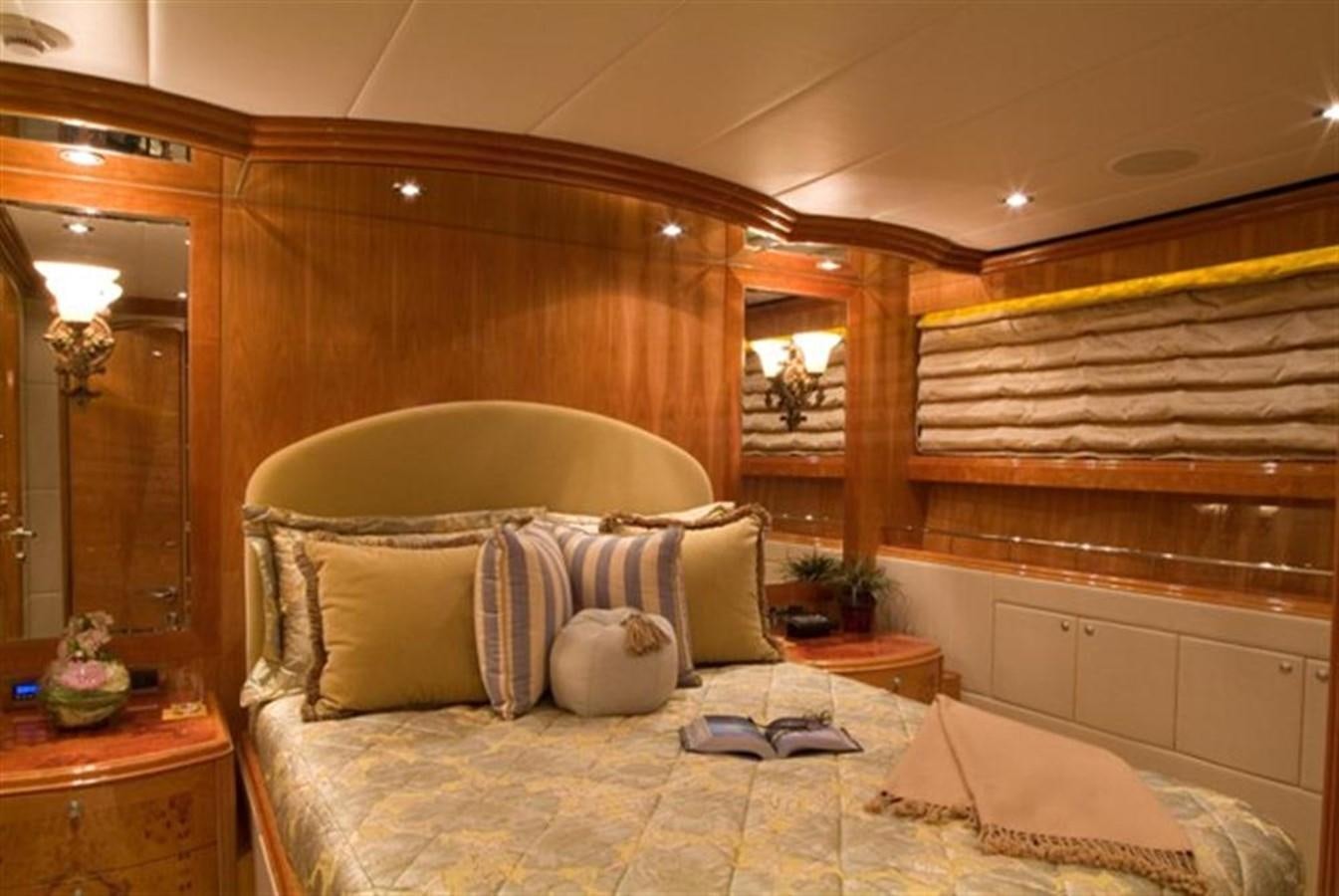 a bed with a white bed spread aboard SEA LEGEND Yacht for Sale
