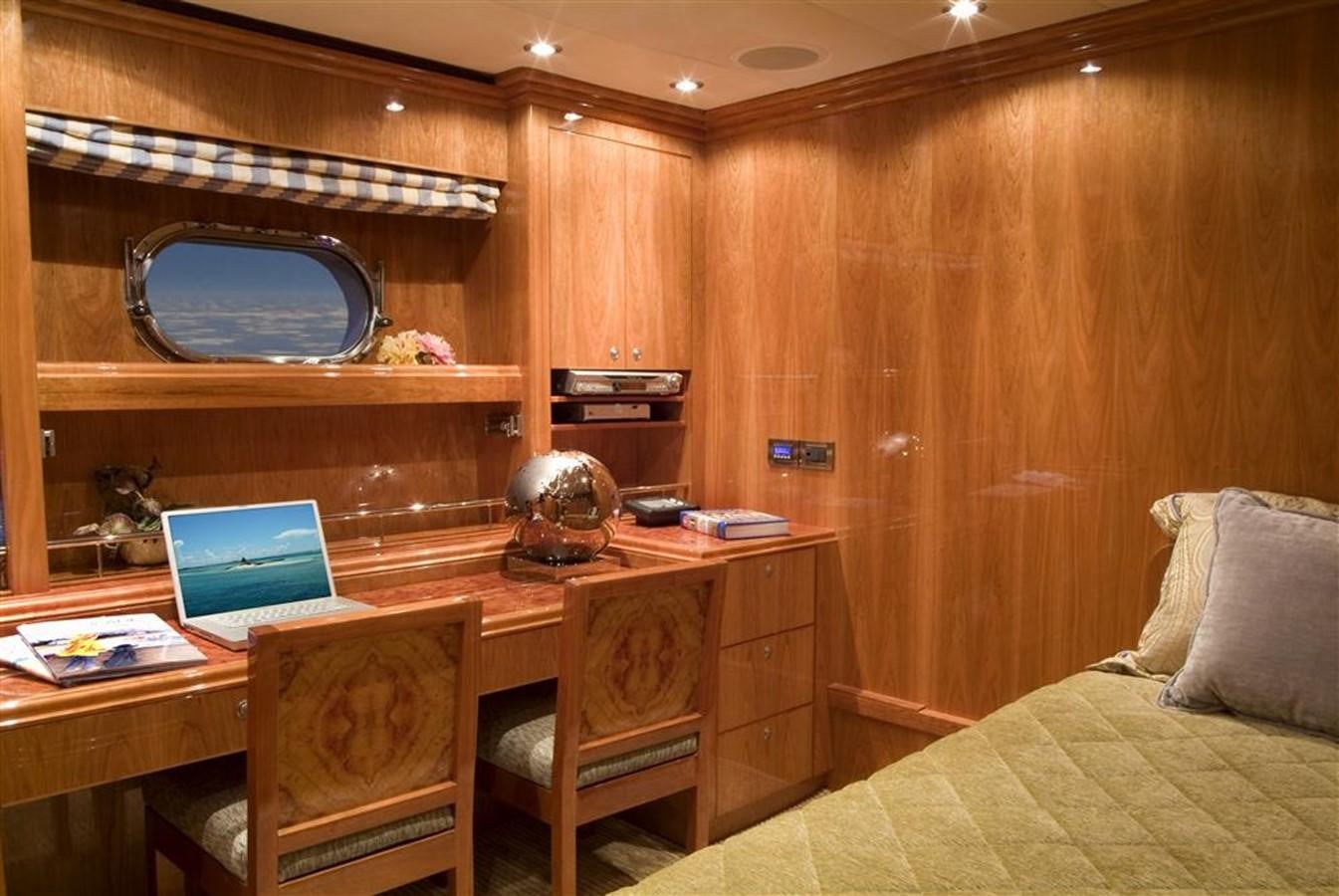a bedroom with a desk and a bed aboard SEA LEGEND Yacht for Sale
