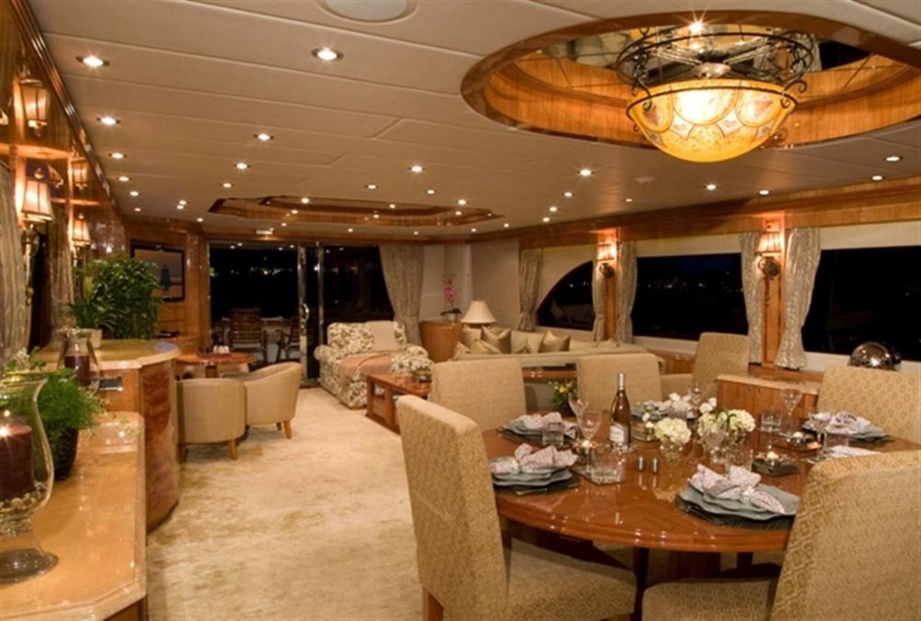 a large room with a table and chairs aboard SEA LEGEND Yacht for Sale