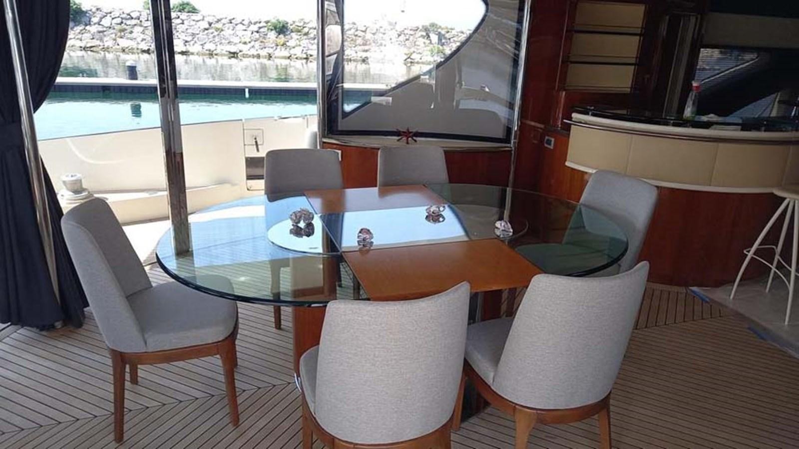 a table and chairs on a boat aboard AEGINA Yacht for Sale