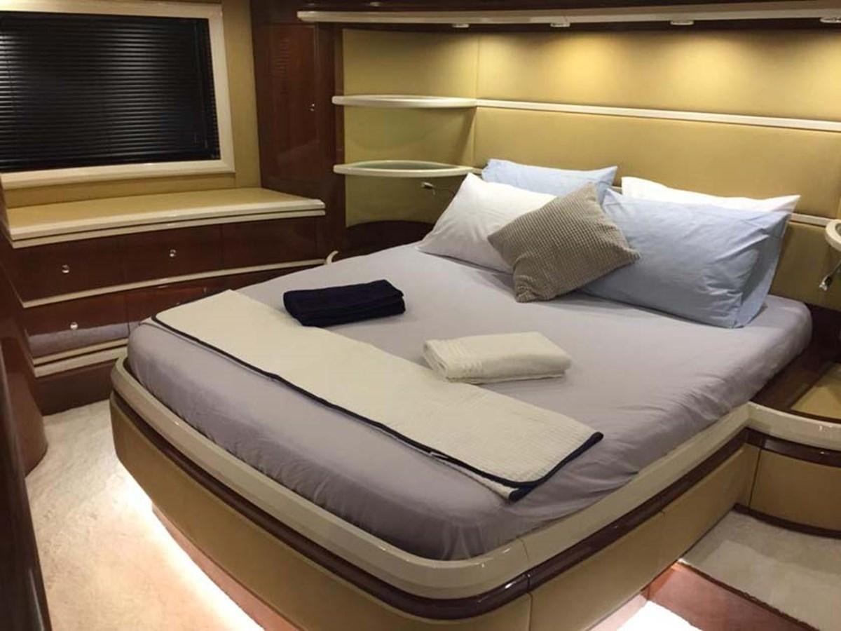a bed with white sheets aboard AEGINA Yacht for Sale