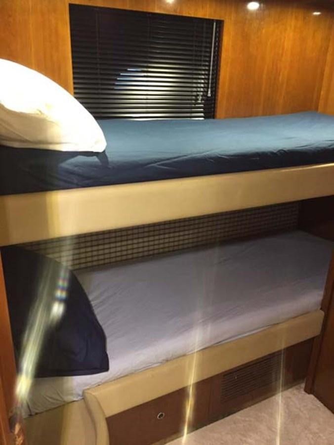 a bed with a blue sheet aboard AEGINA Yacht for Sale