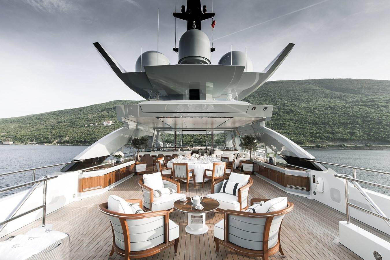 a large white ship docked at a pier aboard GAJA Yacht for Sale