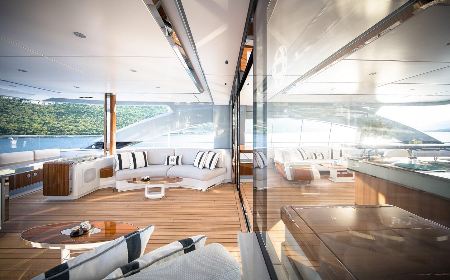 a room with a couch and a table and a view of the water aboard GAJA Yacht for Sale
