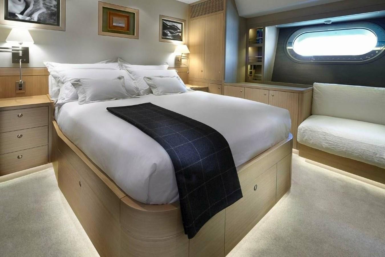 a bed with a blue blanket aboard IMAGINE D Yacht for Sale